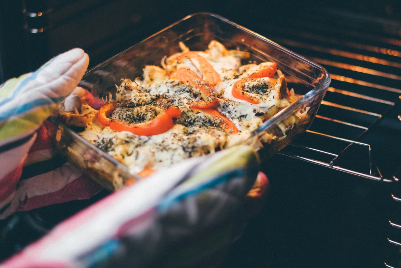 dish being put inside oven