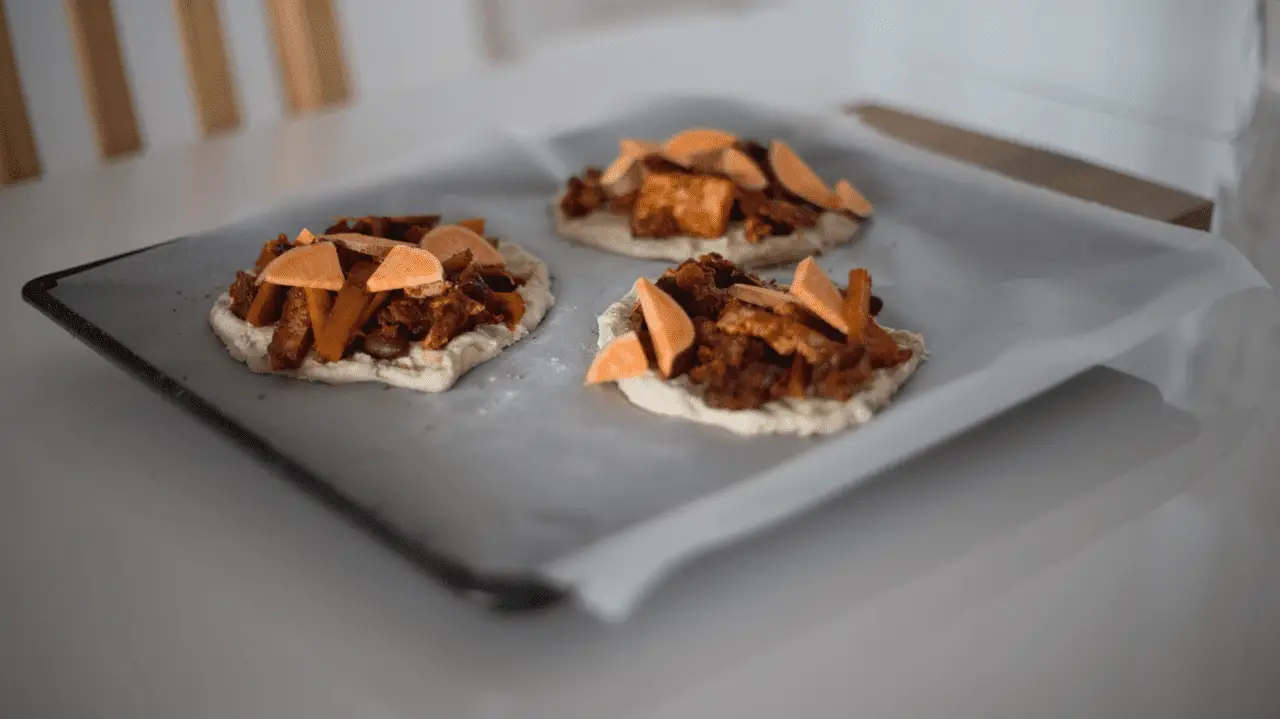 pieces of dough placed on baking pan with wax paper