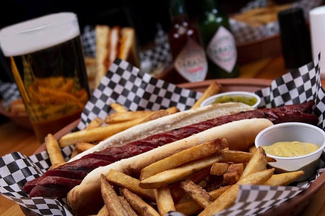 hotdogs and fries with dressing on the side